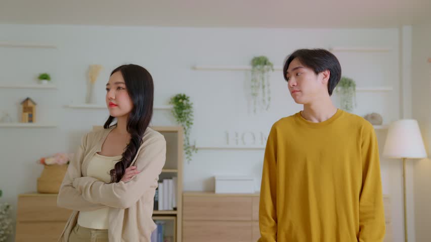 Asian man and woman shouting at each other, couple quarreling in the evening at home husband and wife screaming. Scandal and crisis in family. Domestic violence, abuse, argue, wrathful. Royalty-Free Stock Footage #1100302143