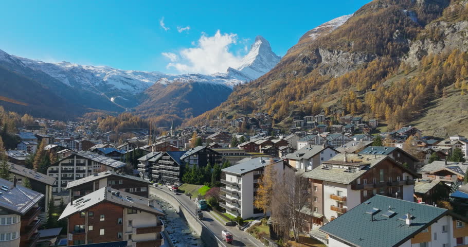 Aerial drone of Zermatt city Valley famous ski resort and iconic Matterhorn peak in autumn season with beautiful landscape in Canton Valais, Switzerland. Swiss alps most popular travel destination.