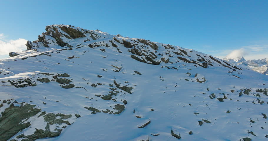 Aerial drone flyover Gornergrat with Matterhorn view during autumn in Switzerland. Majestic mountain peaks iconic famous zermatt travel ski resort in the alps. Wonderful inspiring nature landscape. Royalty-Free Stock Footage #1100306095