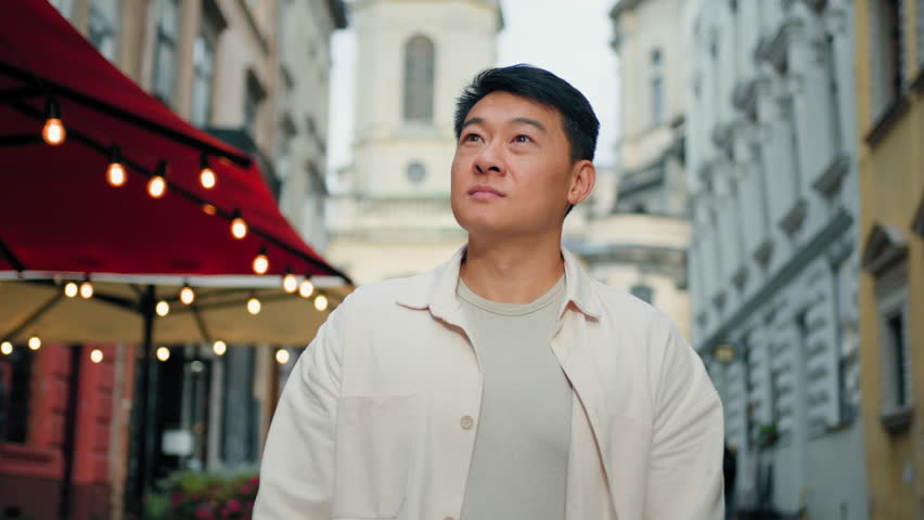 Asian man tourist walk on street in center city look around sightseeing chinese male traveler looking at urban buildings enjoying journey spending vacations travelling walking outdoors travel concept Royalty-Free Stock Footage #1100308027