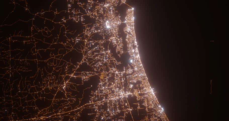 Biloxi (Mississippi, USA) aerial view at night. Top view on modern city with street lights. Camera is zooming out, rotating counterclockwise. Vertical video. The north is on the left side