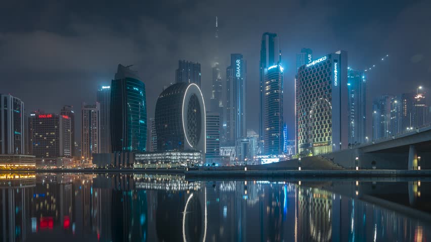 Night foggy Dubai skyline, cityline time lapse. Dubai Creek. Royalty-Free Stock Footage #1100308495