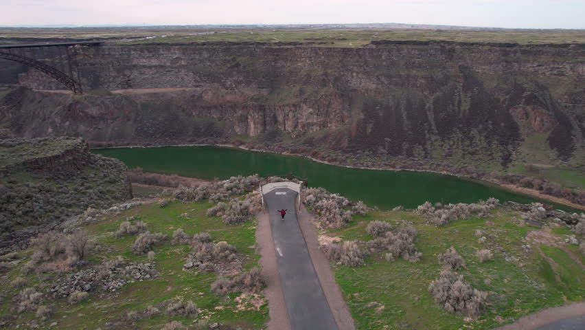Snake River Scenic Overlook, Aerial View of Person Approaching Lookout, Perrine Memorial Bridge and Twin Falls Idaho USA Revealing Drone Shot