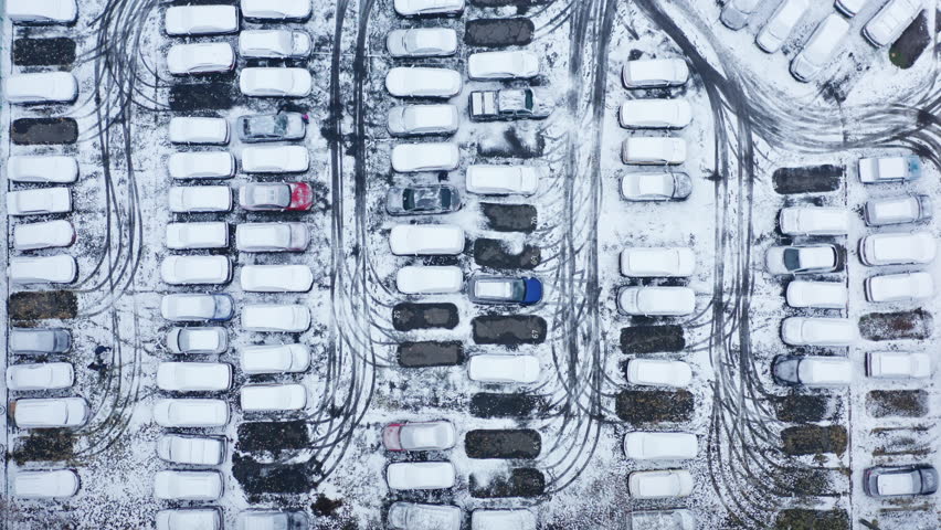 Kyiv, Ukraine. Aerial footage of the dense parking lot in city outskirts. Vehicles covered with snow as seen from above. High quality 4k footage Royalty-Free Stock Footage #1100312855