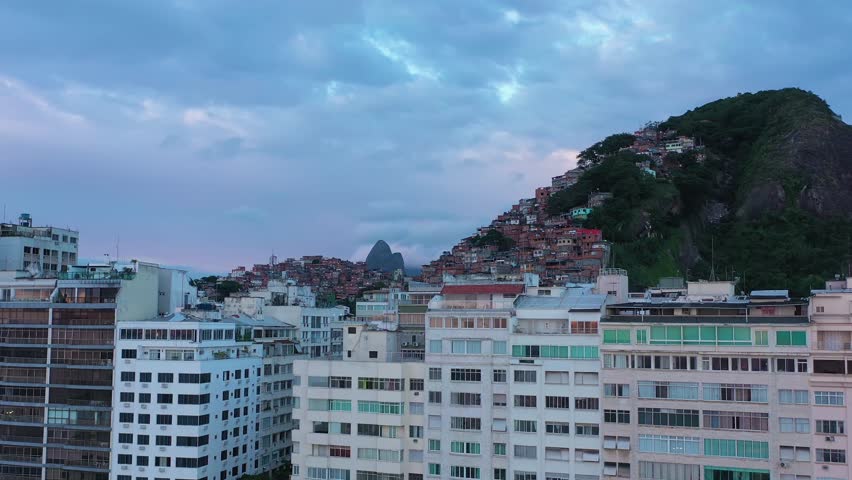 Cantagalo and Pavao-Pavaozinho Favelas on Cloudy Morning. Rio de Janeiro, Brazil. Aerial View. Drone Flies Upwards, Tilt Down. Crane Shot Royalty-Free Stock Footage #1100313375