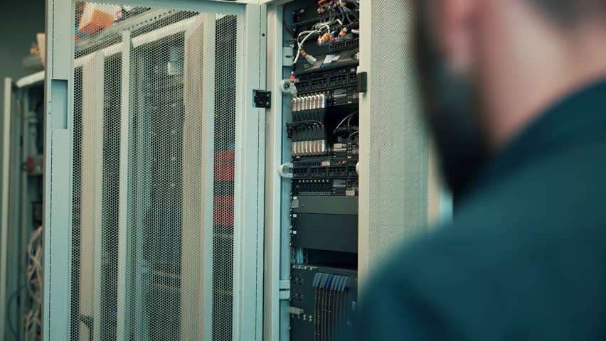 Cable Blockchain Diagnostic Network Engineer In Server Room Mining Farm. It Infrastructure Data Center. It Specialist On Server Racks. Data Security Administrator  Technical Department On Server Room Royalty-Free Stock Footage #1100324911