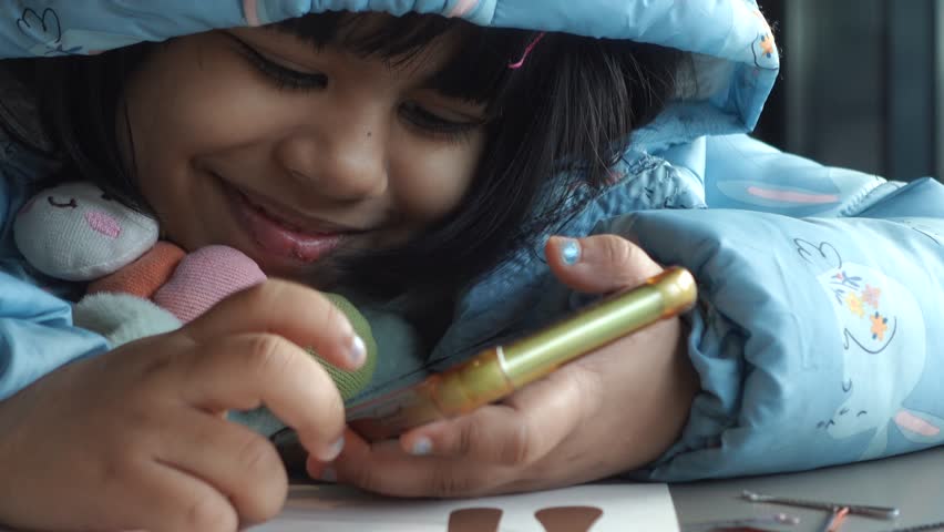 Child girl watching cartoon on smart phone 