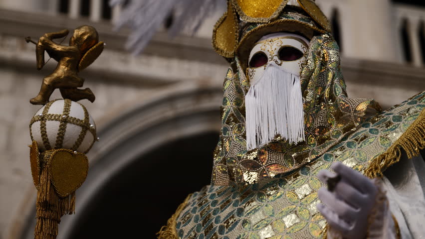 Venice - carnival masks are photographed with tourists in San Marco square