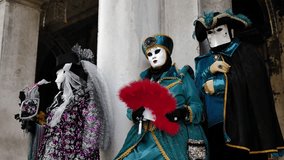Venice - carnival masks are photographed with tourists in San Marco square - Powered by Shutterstock - Get 15% off with code: PIKWIZARD15
