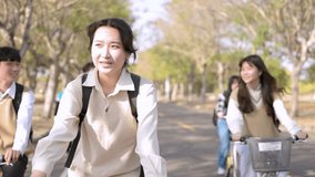 Happy teenager students riding bicycle at the school - Powered by Shutterstock - Get 15% off with code: PIKWIZARD15