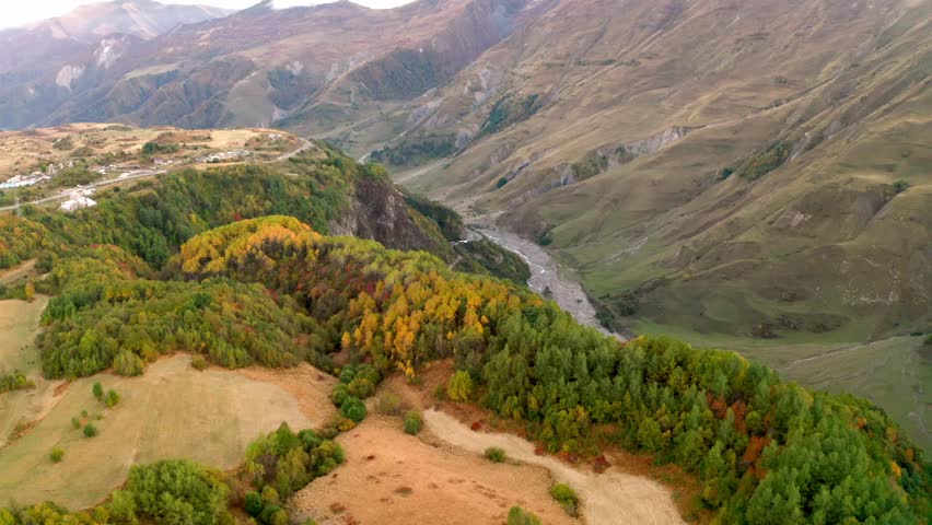 flying over mountain and  river in georgia. autumn day in the mountains. 