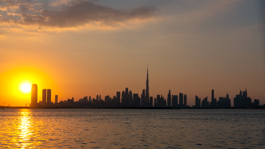 4K day to night Time lapse during sunset of Dubai city skyline with water reflection. Royalty-Free Stock Footage #1100328729