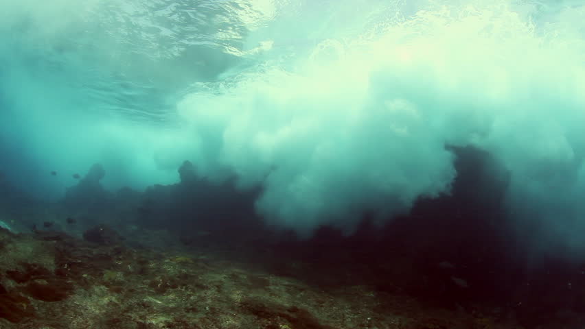 Wave crashing underwater against coral reef of Indian ocean in Sri Lanka subdued and mysterious view.