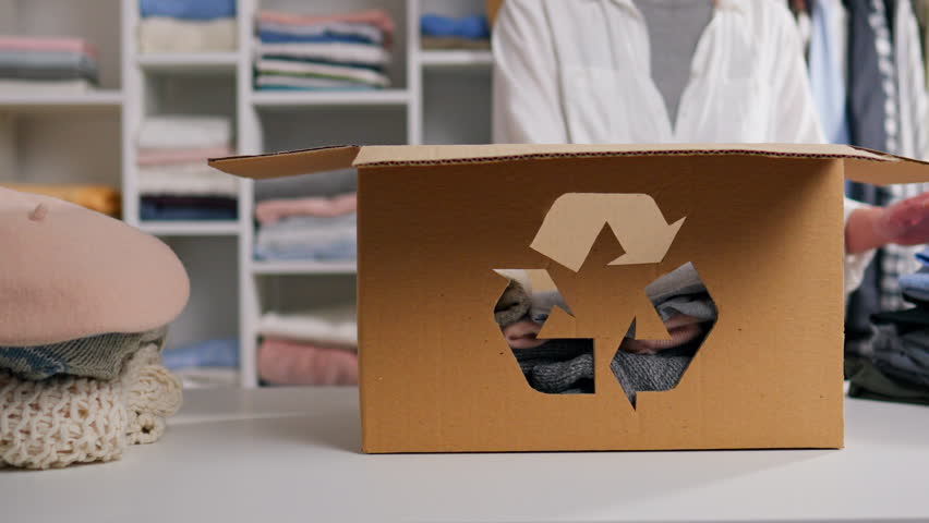Reuse sign, People sort and pack used clothes Leader energetic Boxing Disposable clothes In slow motion Girl activist sorting waste and sustainability indoors, saving the planet from pollution
 Royalty-Free Stock Footage #1100335981