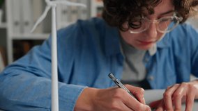 Design Engineer Busily Doing Research Measuring Data on Blueprints Design Engineer Office with Plan and Blueprints of Wind Turbine Designer Conducting Presentation in Engineer Room, Renewable Resource - Powered by Shutterstock - Get 15% off with code: PIKWIZARD15