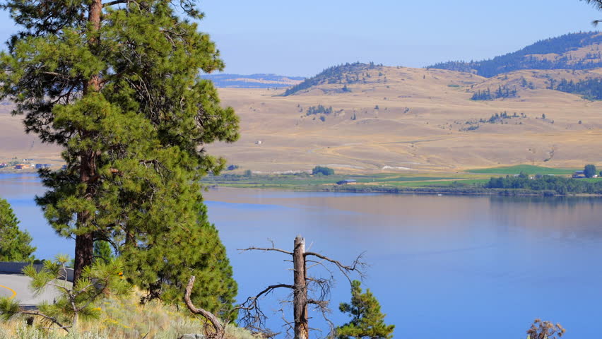 Establishing shot of Mountain lake with blue sky in Vancouver, Canada, North America. Day time on July 2022. Still camera view. ProRes 422 HQ.