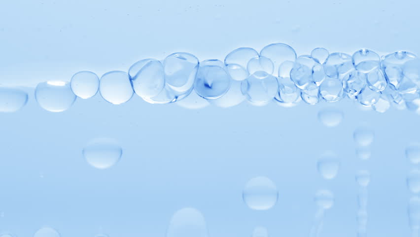 Abstract skin moisturizing products formulation concept | Macro shot of blue clear bubbles form and float to another ones on blue transparent liquid surface on blue background | Shutterstock HD Video #1100344703