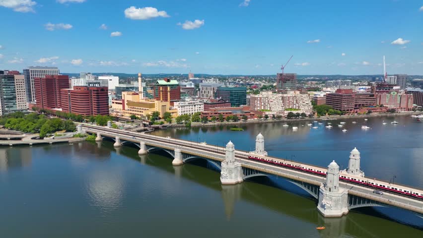 MBTA red line on Longfellow Bridge cross over Charles River, with Cambridge Kendall Square skyline at the background, Cambridge, Massachusetts MA, USA.  Royalty-Free Stock Footage #1100345201