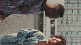 VERTICAL VIDEO, Classmates are walking down the street. Guy and girl students are walking down the street and talking - Powered by Shutterstock - Get 15% off with code: PIKWIZARD15