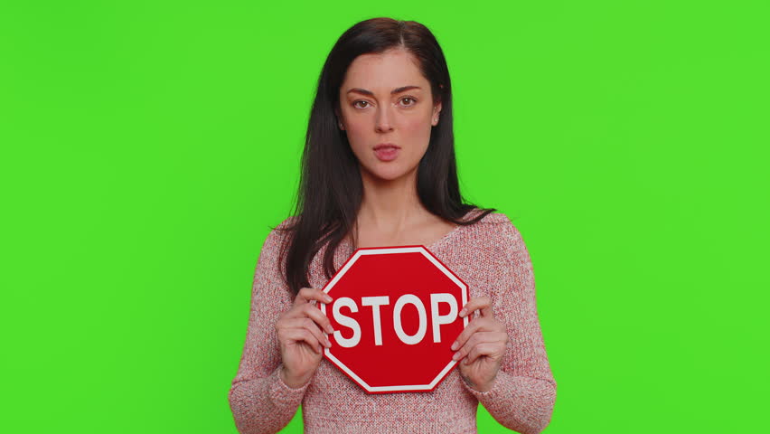 Serious pretty woman say No, hold inscription text red No stop danger sign, warning of finish, prohibited access declining communication, body language, trouble, protest. Girl on chroma key background