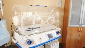 Neonatal intensive care advanced equipment. Monitoring equipment of premature infant. Tubes and wires from apparatuses in postpartum. Equipped medical room. 4 k video