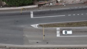 Crossroads seen from above, fast moving cars, intertwined roads. Drone video above.
