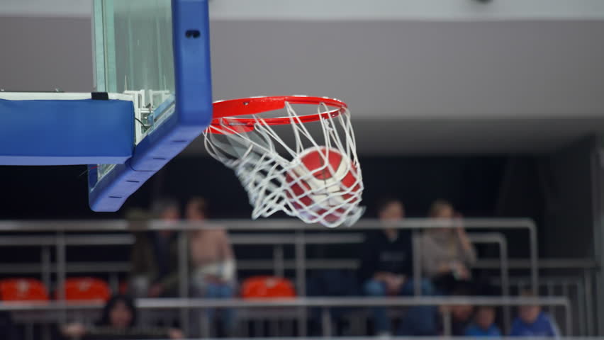 Basketball player putting a ball in the hoop, closeup sports concept indoors. High quality 4k footage | Shutterstock HD Video #1100350049