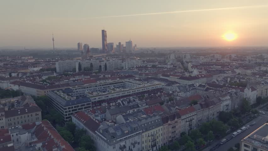 Flying above the houses of the Capital of Austria, Vienna during sunset.