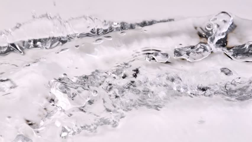 Slow motion of pouring splashing water on white background. | Shutterstock HD Video #1100353295