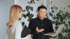 Startup investment diverse business meeting between asian investor and caucasian female startupper businesswoman. Business poeople discussing new project, financial market data using laptop.  - Powered by Shutterstock - Get 15% off with code: PIKWIZARD15