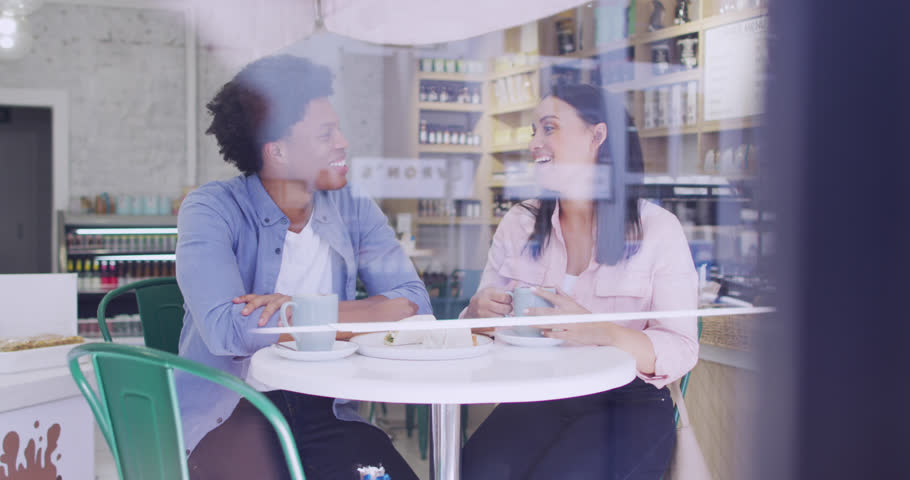 Animation of icons and data processing over diverse people drinking coffee in cafe. Global shopping, business, finance, computing and data processing concept digitally generated video.