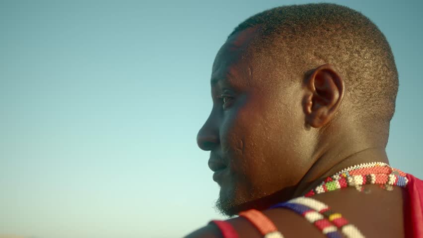 Side View Of An African Masai Warrior Looking Over The Horizon In Kenya During Daytime. Close up Royalty-Free Stock Footage #1100357591