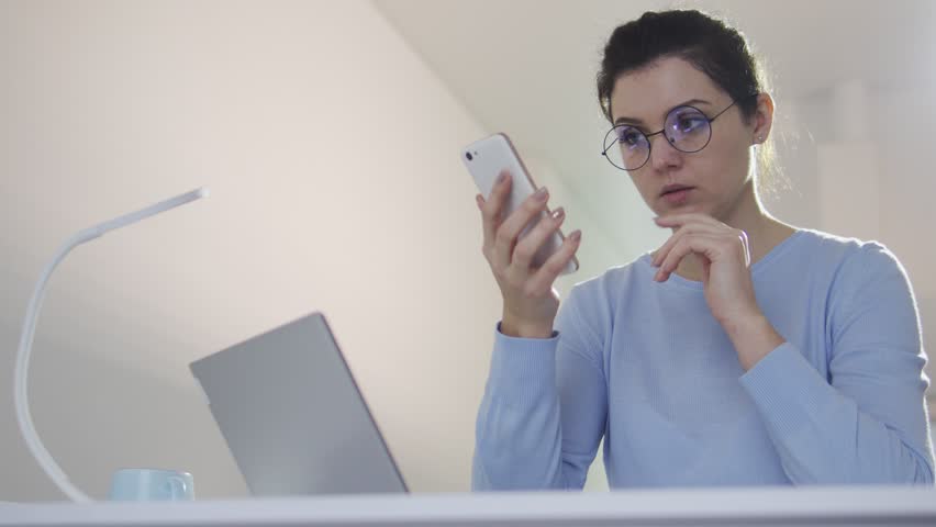 Dissatisfied young woman trying to log in in app on smartphone, forget password, problems with operative system, bugs and lugs with network, spamming Royalty-Free Stock Footage #1100358849