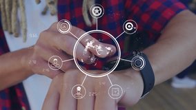 Animation of network of connections with icons over man using smartwatch. Global networks, business, finance, computing and data processing concept digitally generated video. - Powered by Shutterstock - Get 15% off with code: PIKWIZARD15