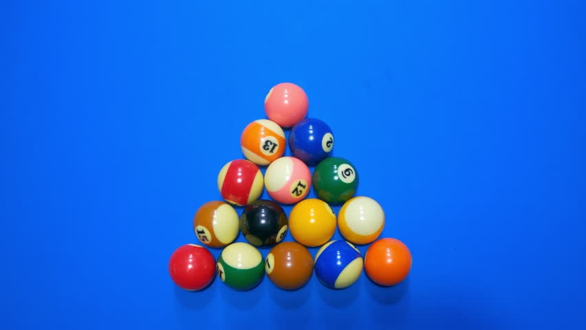 Top view of the beginning of the billiard game breaking balls. The moment of playing billiards on a table with a blue coating. The first hit with a white ball on triangle of balls. Film grain texture. | Shutterstock HD Video #1100365451