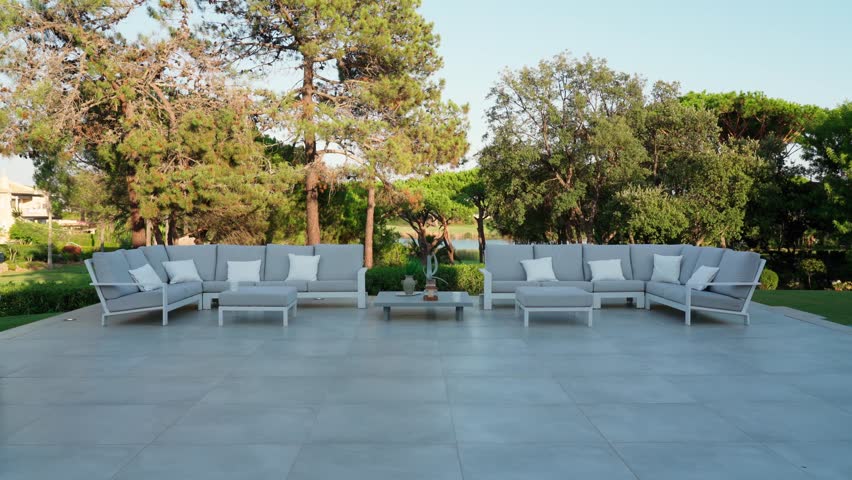 Stylish outdoor dining furniture in a hotel or villa with a view of the green garden. Royalty-Free Stock Footage #1100366003
