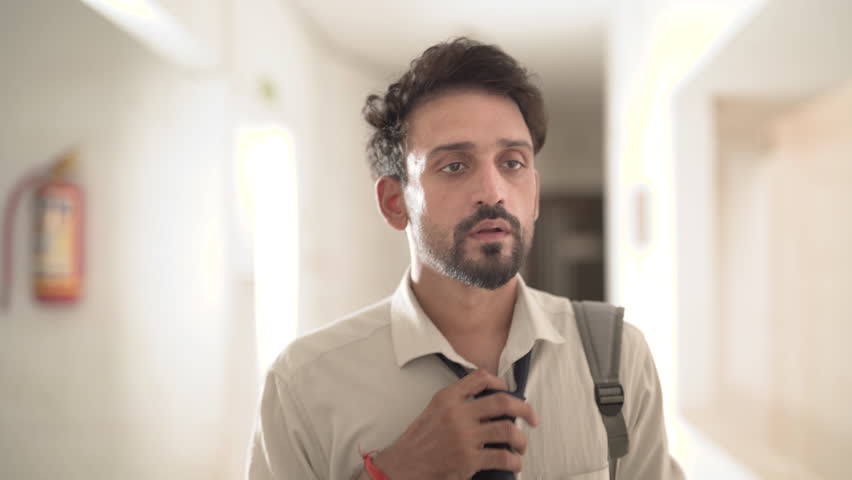 Unhappy anxious tired young boy in formal dress in deep thought walking in hallway. Sad Indian middle-aged bearded man in tie touch hair thinking about lost jobless career. Depression, crisis hopeless Royalty-Free Stock Footage #1100366929