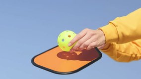 woman playing pickleball game, hitting pickleball yellow ball with paddle, outdoor sport leisure activity - Powered by Shutterstock - Get 15% off with code: PIKWIZARD15