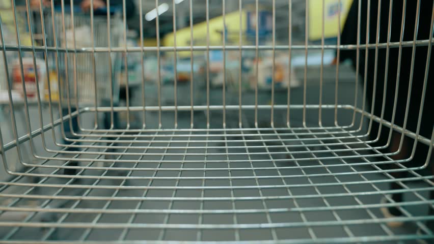 Timelapse of filling a shopping cart with various food products in a supermarket Royalty-Free Stock Footage #1100381683