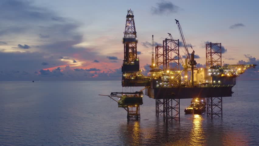 Jack up drilling rig and production platform in the middle of the ocean at sunrise time
 Royalty-Free Stock Footage #1100382881