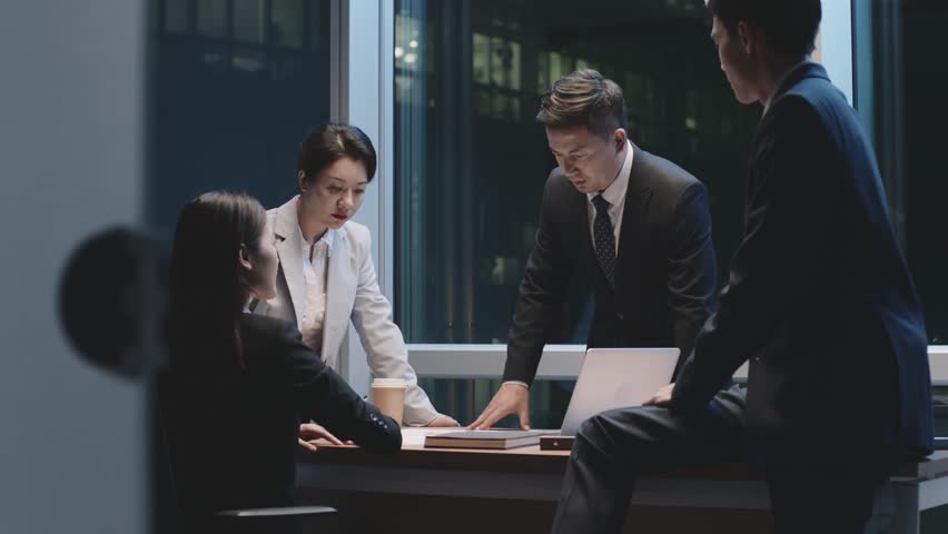 team of asian business people men and women working late meeting in office at night Royalty-Free Stock Footage #1100384303