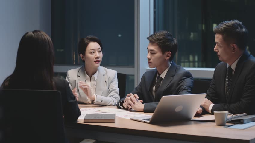 Team of asian business people men and women working late meeting in office at night | Shutterstock HD Video #1100384305
