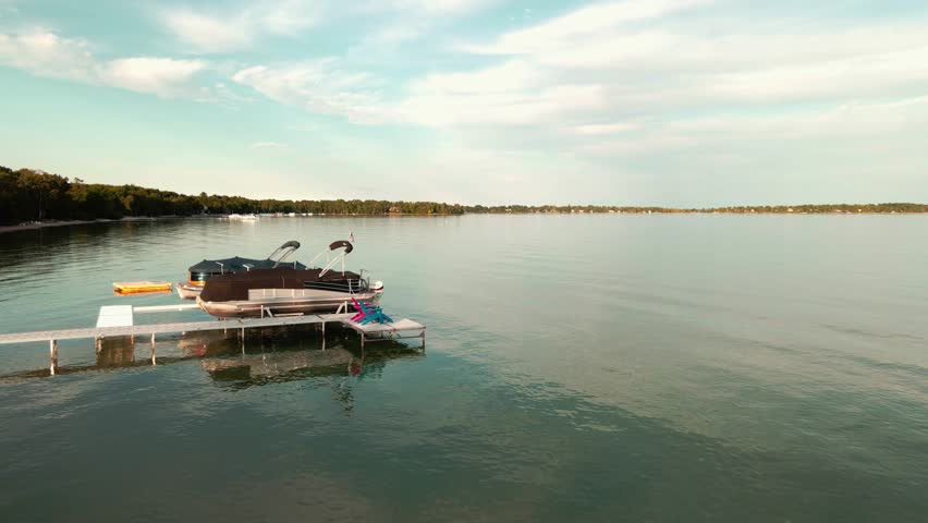 Small motor boat docked at small pier in Lake Leelanau, Michigan