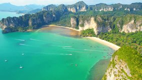Drones are flying over the tropical sea coast, green limestone mountains. Krabi, The Most Beautiful Destinations in Thailand. Places in Asia you must visit at least once in your life. Natural video
