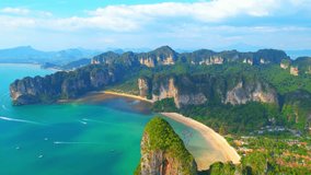 Majestic scenery over Railay Beach, coastal limestone mountains. Krabi, Thailand. Tropical sea on a good weather. Travel destination concept. beach video background. High quality 4k footage. Aerial
