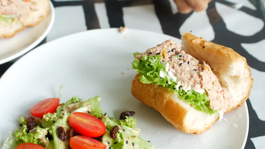 Tuna sandwich with mayonnaise on a plate on table  | Shutterstock HD Video #1100392179