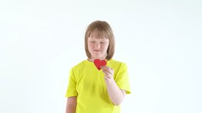 Sweet little girl holding paper heart. Down syndrome awareness concept. International Down Syndrome Day. - Powered by Shutterstock - Get 15% off with code: PIKWIZARD15