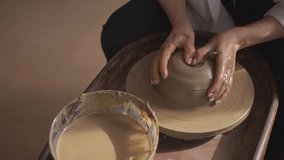 girl works on a potter's wheel. close-up.slow-motion video.High-quality video recording in FullHD format
