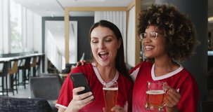 Animation of media icons over happy diverse female friends drinking beer. Party and celebration concept digitally generated video.