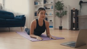 Pretty Asian woman recording video for blog, fitness influencer planking at home